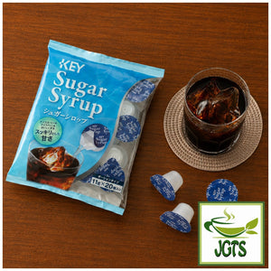 (Key Coffee) - Sugar Syrup - Package and dish of syrup at a coffee shop